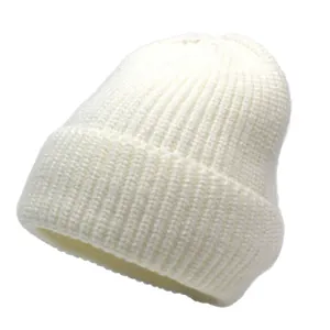 Close-up of white ribbed knit beanie showing textured cotton cashmere warmth detail