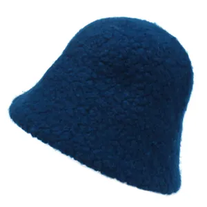 Detail of soft plush fleece texture on a navy blue winter bucket hat for women