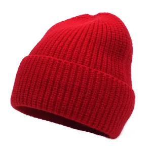 Close-up of bright red ribbed knit beanie showing soft cashmere-cotton texture