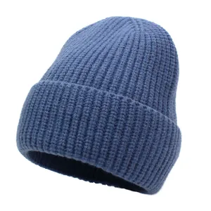 Detail of blue ribbed knit beanie showing soft wool texture and folded cuff style
