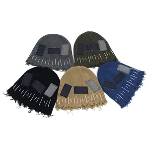Distressed knit beanie hats with patches and frayed edges in five assorted colors