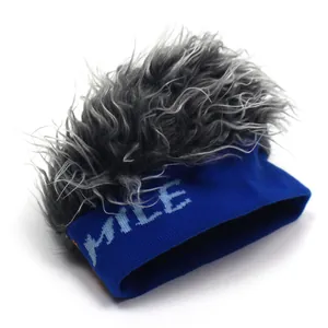 Detail of knit beanie featuring grey long faux fur hair and blue HYILE text decoration