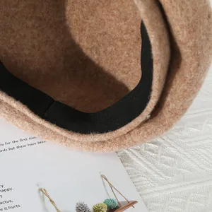 Detail of khaki wool beret inner lining with black elastic sweatband and neat stitching
