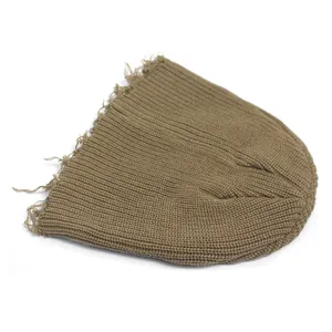 Detailed close-up of a brown ribbed knit beanie with vintage distressed fringe edges