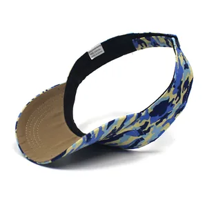 Detail view of cotton camouflage sun visor showing 100% cotton label and inner sweatband