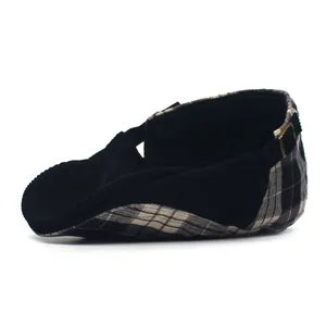 Detail view of retro corduroy and plaid patchwork flat cap with metal side buckle