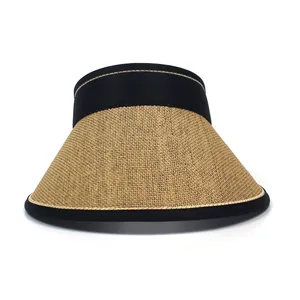 Close-up of woven paper straw texture on a sun hat with black ribbon and gold piping trim