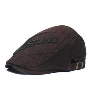 Quilted cotton flat cap in dark brown with embossed side embroidery and metal buckle