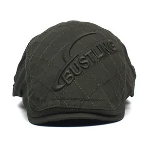 Detailed close-up of dark green quilted cotton flat cap with BUSTLING embroidery
