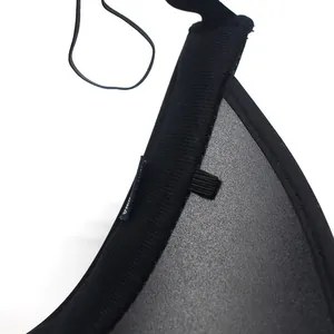 Detailed macro shot of black ribbed knit fabric with elastic strap and care label