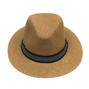 Detail of khaki woven straw hat with classic black and white ribbon trim for sun protection