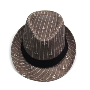 Top view of brown striped fedora hat featuring white anchor prints and black ribbon band