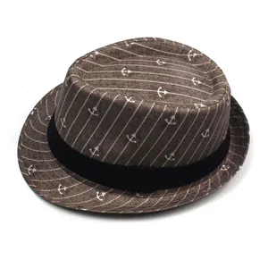 Detail of nautical anchor print and white stripes on dark brown jazz fedora hat