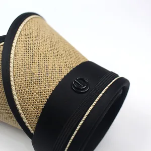Macro detail of foldable straw sun visor showing woven texture and black fabric trim