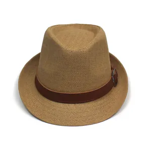 Close-up of the woven straw texture and dark brown leather belt with silver buckle