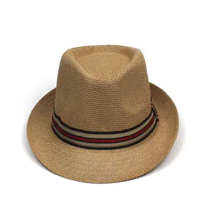 Detail of a straw fedora featuring a red and green striped band on a natural weave