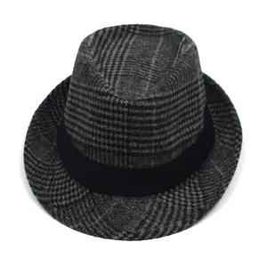 Detail of grey plaid fedora hat with a black decorative ribbon and soft brushed texture