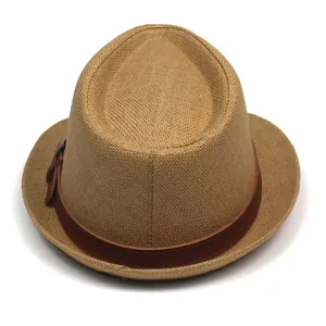 Close-up of woven straw fedora hat featuring a brown leather band and metal buckle
