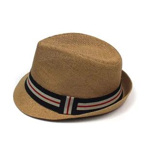 Detail of the paper straw fedora hat featuring a classic red, white, and blue striped band