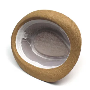 Detail view of woven straw hat interior with 100% paper material label and sweatband