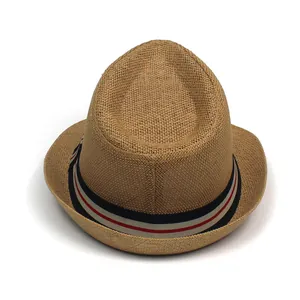 Close-up of khaki straw fedora hat featuring a red, white, and blue striped ribbon band