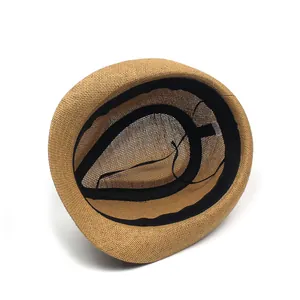 Close-up of the breathable paper straw texture and inner black sweatband of the fedora hat