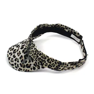 Detail shot of leopard print sun visor hat showing 100% polyester label and black sweatband
