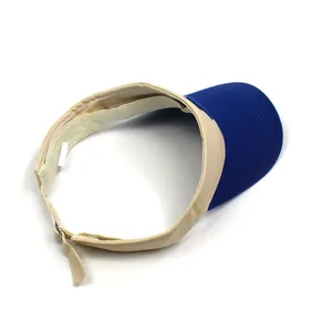 Detail of cotton sun visor with blue brim, beige fabric and adjustable metal buckle
