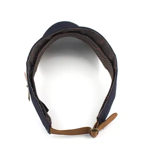 Detailansicht der marineblauen Sonnenblende mit Karofutter und braunem Leder-Verstellband