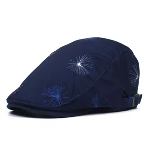 Detail of navy cotton beret featuring white dandelion print and adjustable metal side buckle