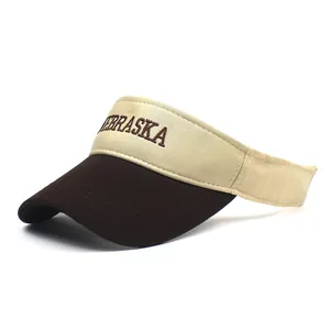 Detail of embroidered NEBRASKA logo on cotton sun visor hat with two-tone fabric texture