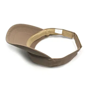 Detail view of cotton sun visor interior with wash label and adjustable strap