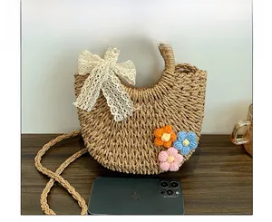 Straw bag size reference with phone showing woven flowers and lace bow detail
