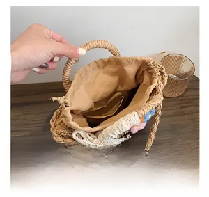 Detail of straw bucket bag interior showing drawstring lining and crochet flowers