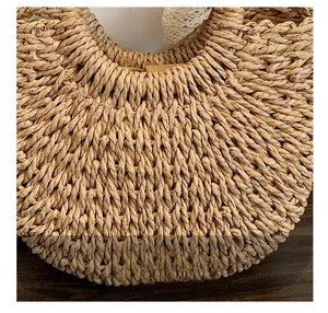 Detail of hand-woven straw texture and white lace trim on a beach tote bag