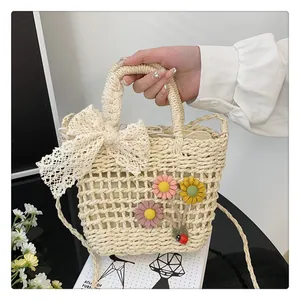 Detailed close-up of straw woven bag featuring lace bow and handmade 3D floral accents