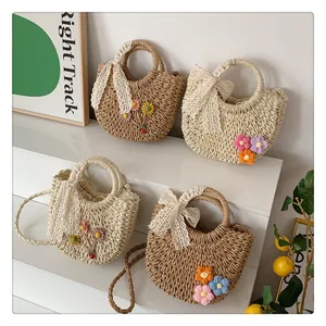Detailed view of handmade straw bags featuring 3D crochet flowers and lace bows