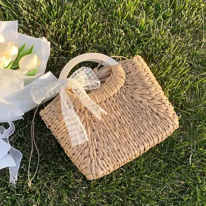 Straw tote bag with daisy lace bow and round handle for summer beach vacation