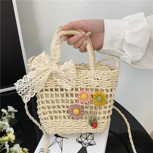 Lace straw handbag with floral accents and ribbon for summer beach vacations