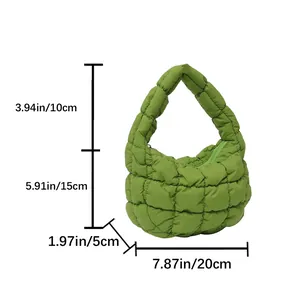 Detail of green puffer handbag showing quilted square texture and zip closure dimensions