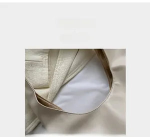 Detail view of cream PU leather handbag showing fine stitching and soft fabric lining