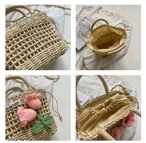 Detail of straw woven tote with floral crochet tulips and drawstrings for security