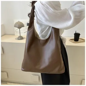Brown large capacity PU leather hobo bag worn on shoulder for stylish daily commuting