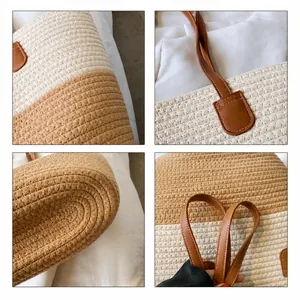 Detail view of the beige woven straw bag featuring a brown leather handle and stitching