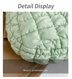 Close-up of the light green quilted nylon fabric with detailed diamond stitching pattern