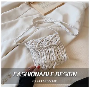 Detailed macro view of cream Macrame woven texture and fringe on bohostyle shoulder bag