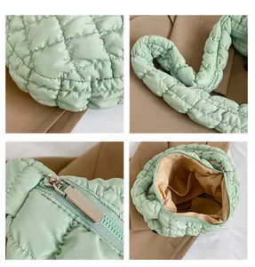 Detail shots of mint green quilted tote showing textured fabric and silver zipper