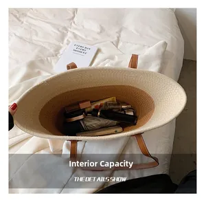 Top view of large capacity straw bag showing interior space for phone and umbrella