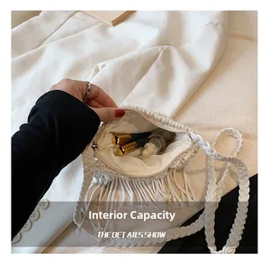 Internal capacity of straw crossbody bag showing lining, zipper, and fringe details