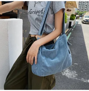 Detail of adjustable wide shoulder strap on light blue denim tote bag for women
